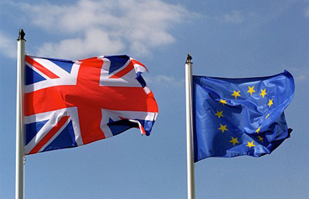 A United Kingdom flag flying next to a European Union flag